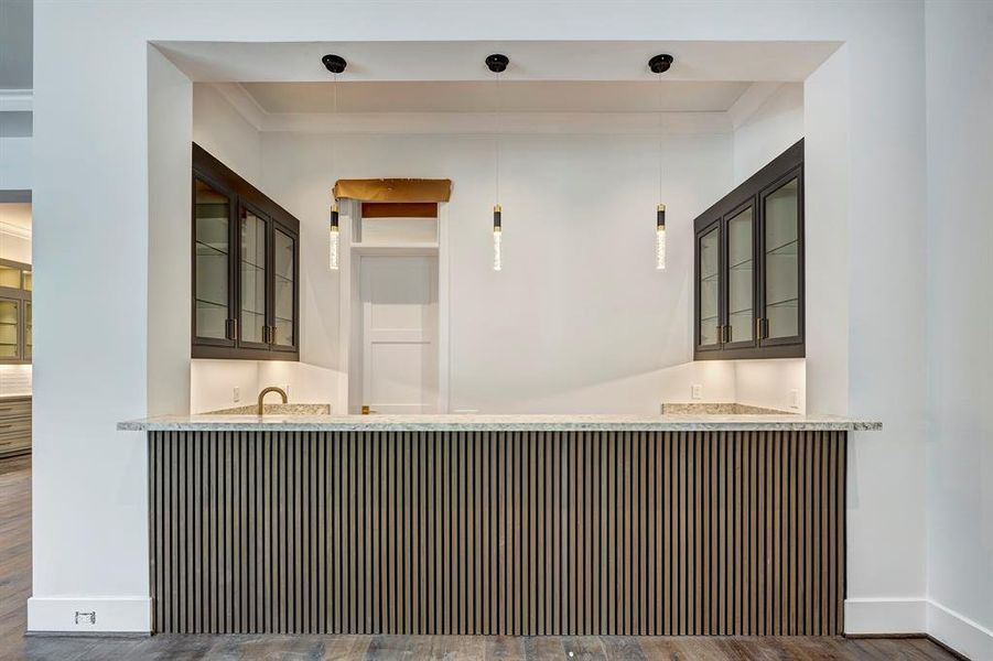 Expansive wet bar designed for effortless entertaining, featuring generous countertop space, abundant custom cabinetry, and sleek drawers—combining style and function in a true entertainer’s dream. Stage of construction as of June 15, 2025. Expansive wet bar designed for effortless entertaining, featuring generous countertop space, abundant custom cabinetry, and sleek drawers—combining style and function in a true entertainer’s dream. Stage of construction as of June 15, 2025.