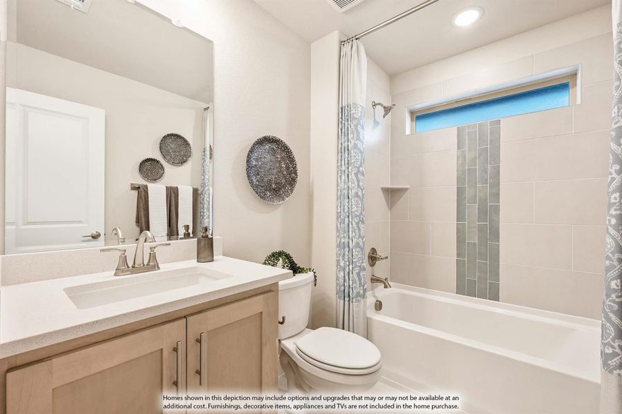 Bathroom with wood vanity, white countertop, tiled shower-tub combo, and small window above the tub