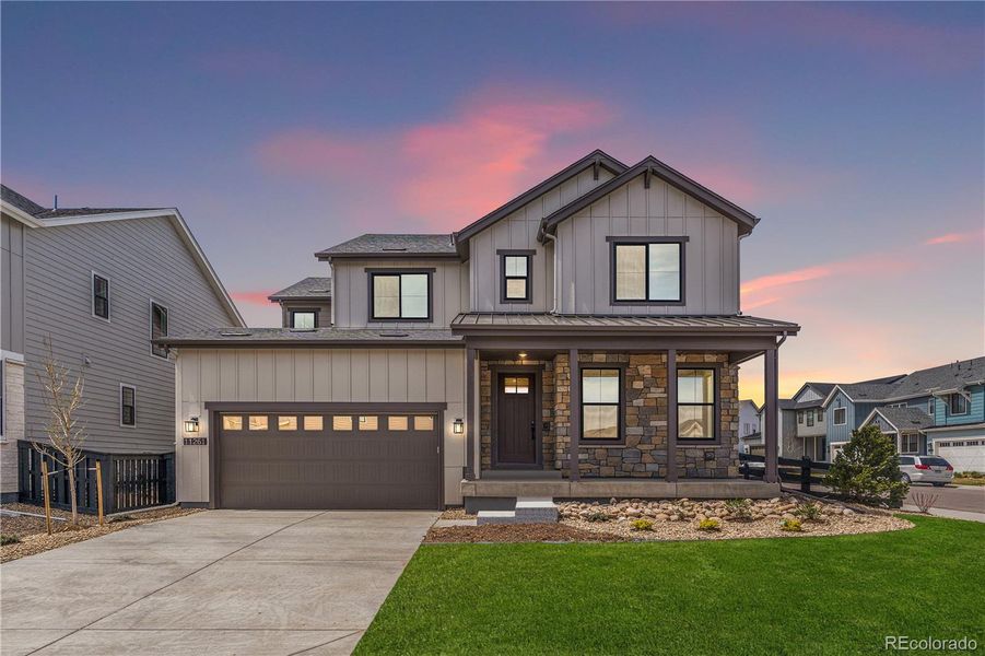 Front exterior of a new home in Stargaze at Solstice, Littleton, CO, highlighting curb appeal (Image 1). Front exterior of a new home in Stargaze at Solstice, Littleton, CO, highlighting curb appeal (Image 1).