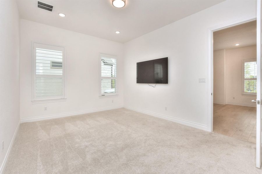 Spare room featuring light colored carpet and recessed lighting