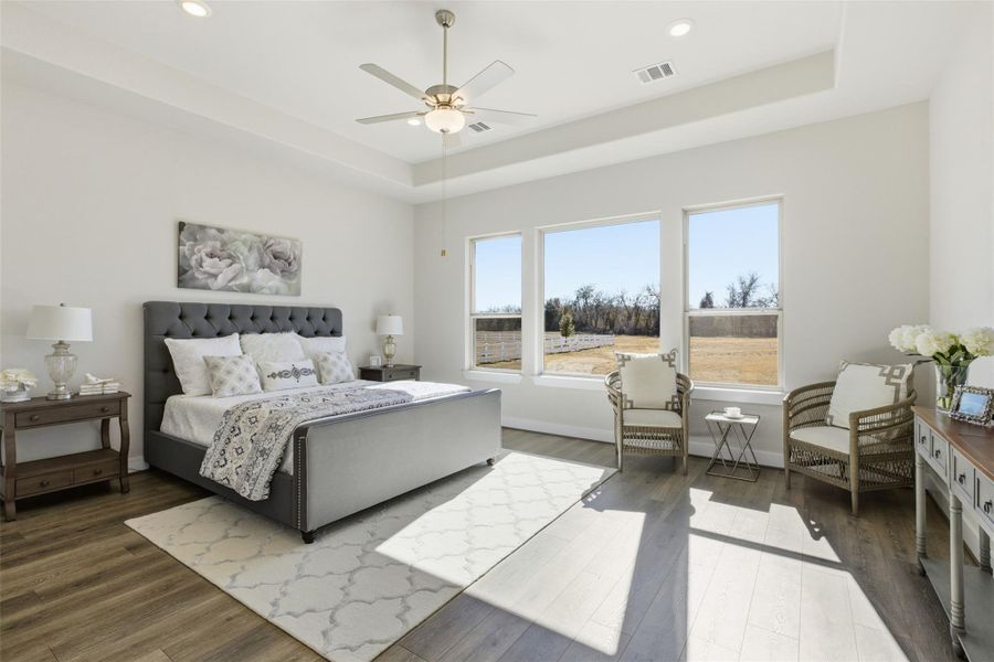 Bedroom featuring ceiling fan, wood finished floors, a tray ceiling, and recessed lighting