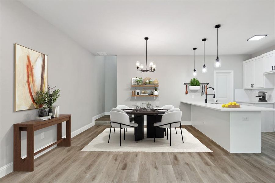 Dining area with light wood-type flooring, sink, and a chandelier