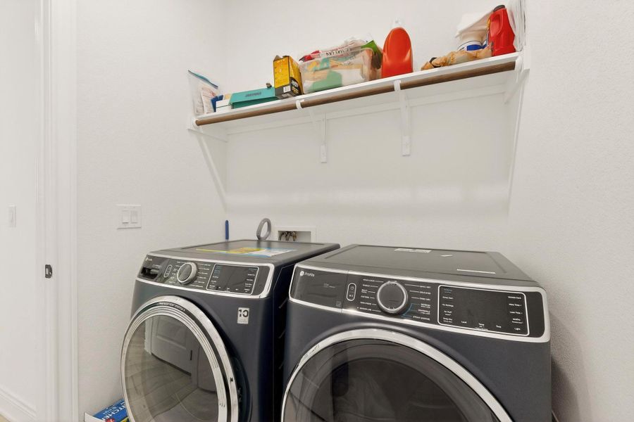 Laundry room with washing machine and clothes dryer