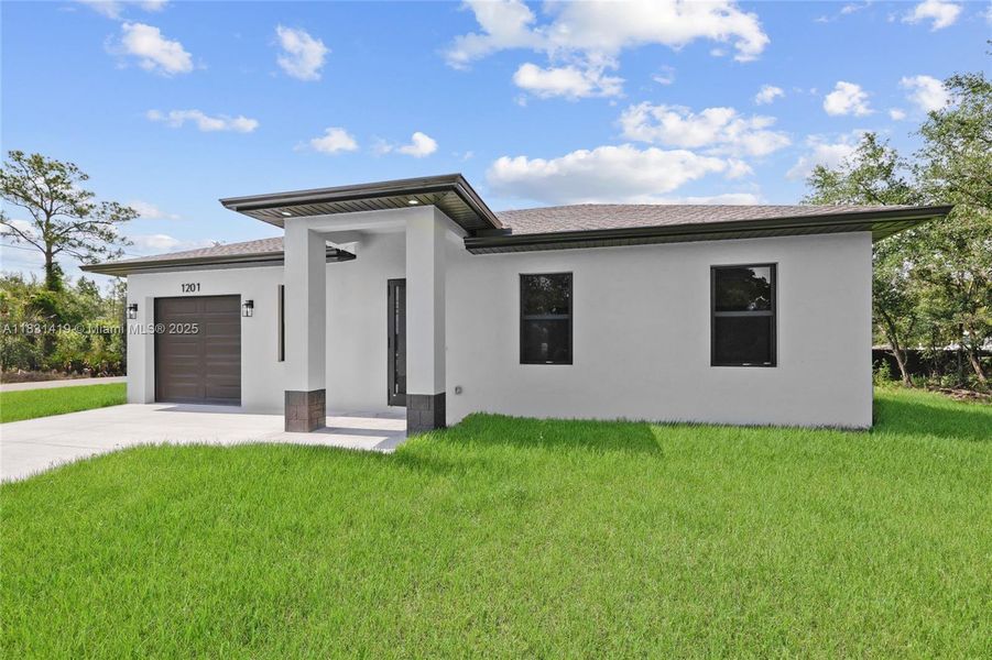 Front exterior of a new home in , Lehigh Acres, FL, highlighting curb appeal (Image 14).