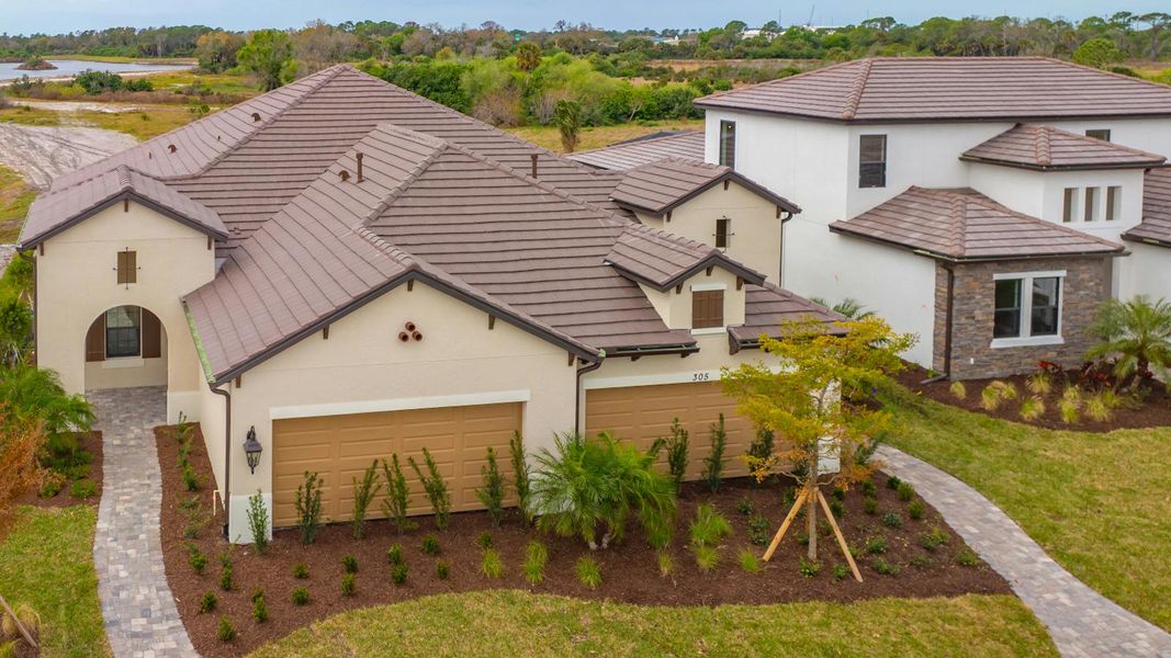 Front exterior of a new home in Vistera of Venice Real Estate and Homes for Sale in Venice, FL - Neal Communities, Nokomis, FL, highlighting curb appeal (Image 22). Front exterior of a new home in Vistera of Venice Real Estate and Homes for Sale in Venice, FL - Neal Communities, Nokomis, FL, highlighting curb appeal (Image 22).
