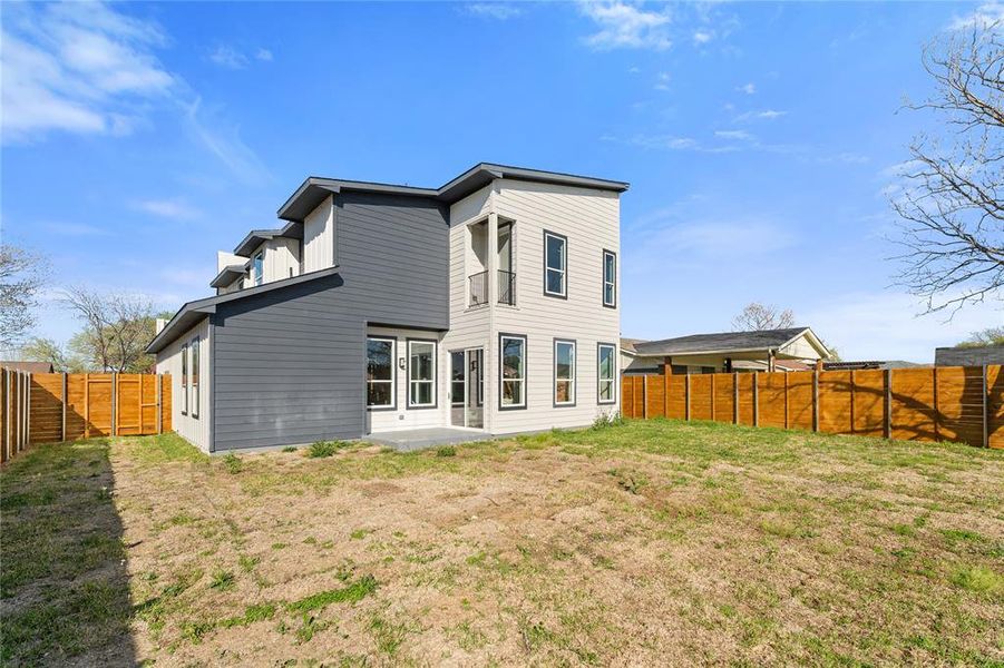 Back of property featuring a patio and a fenced backyard