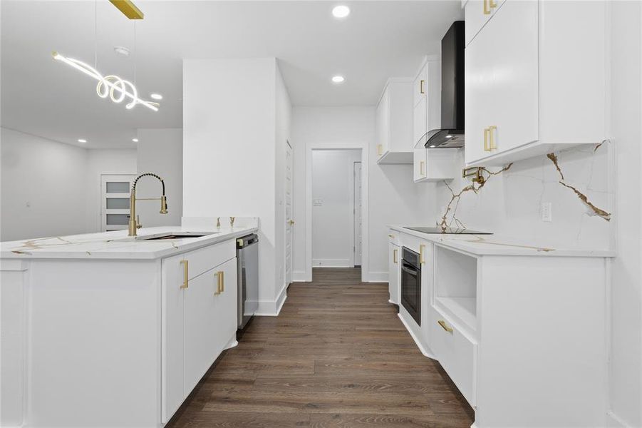 Contemporary kitchen featuring white cabinetry, gold-finish hardware, and a gold-finish pull-down faucet