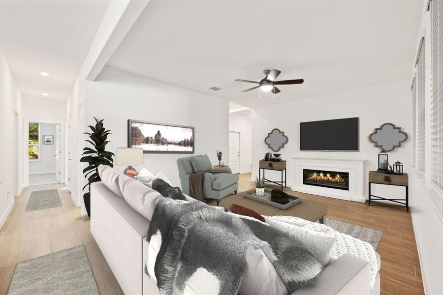 Living room featuring a glass covered fireplace, light wood-style flooring, a ceiling fan, and recessed lighting Living room featuring a glass covered fireplace, light wood-style flooring, a ceiling fan, and recessed lighting