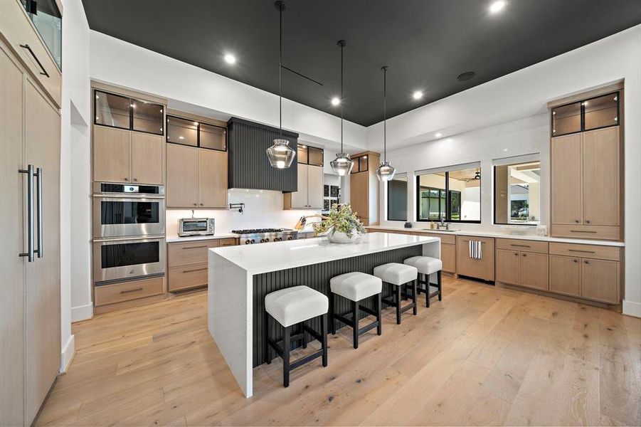 Beyond a chef's kitchen with large island/breakfast bar