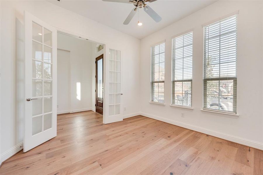 Unfurnished room with ceiling fan, french doors, and light hardwood / wood-style floors