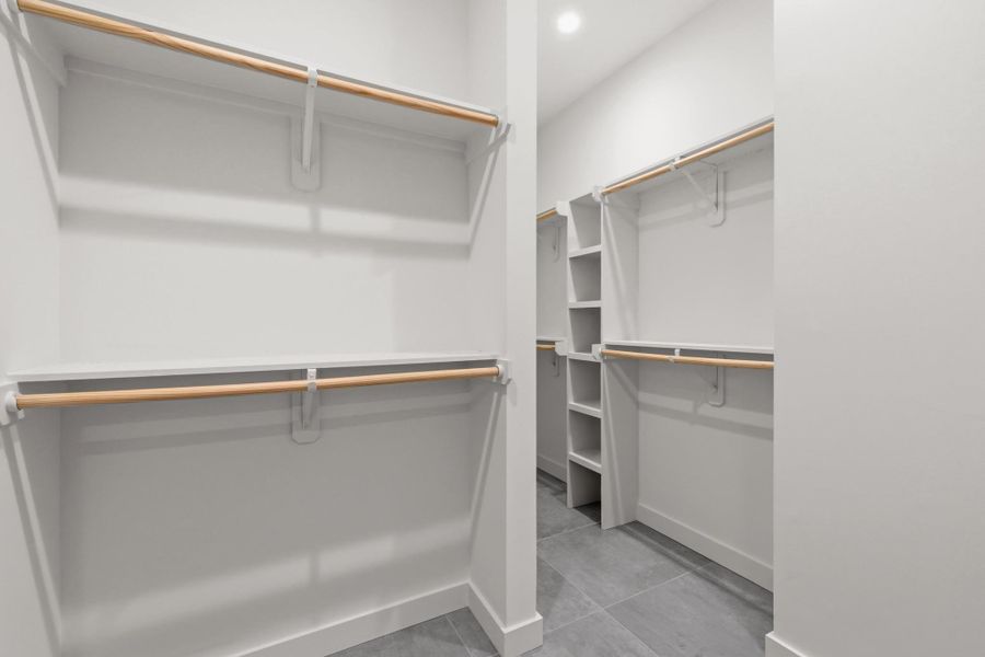 Enjoy the spacious walk-in closet with custom shelving off the primary bathroom