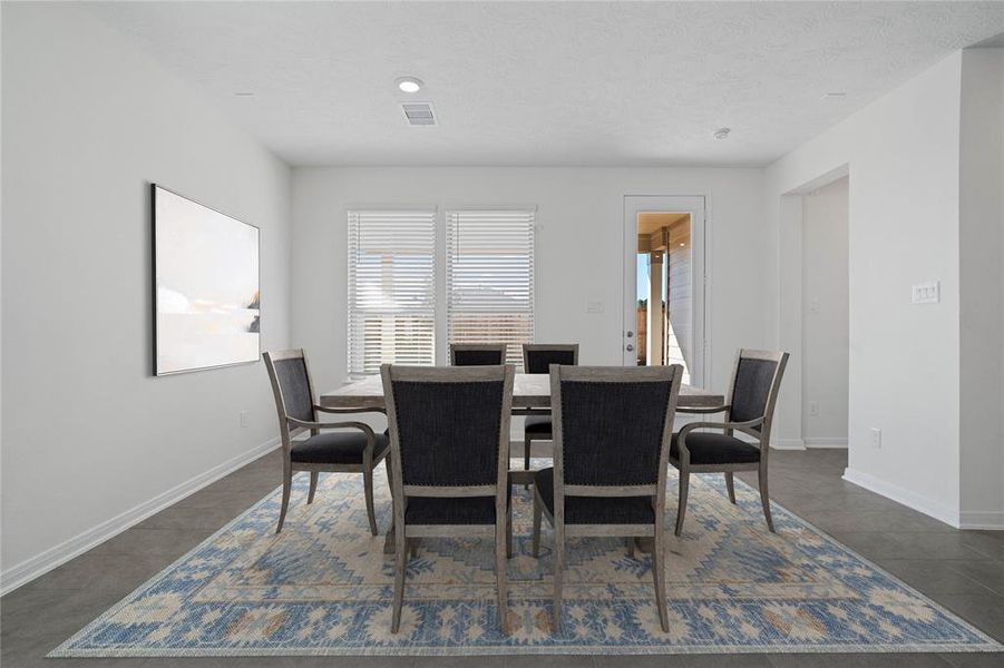 Make memories gathered around the table with your family and friends! This flex space is featured here as a dining room and it features high ceilings, large windows with privacy blinds, and easy access to your kitchen and living room.