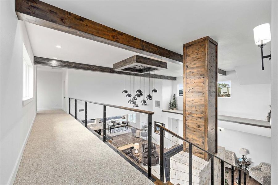 Hallway featuring healthy amount of natural light, beamed ceiling, an upstairs landing, and carpet floors
