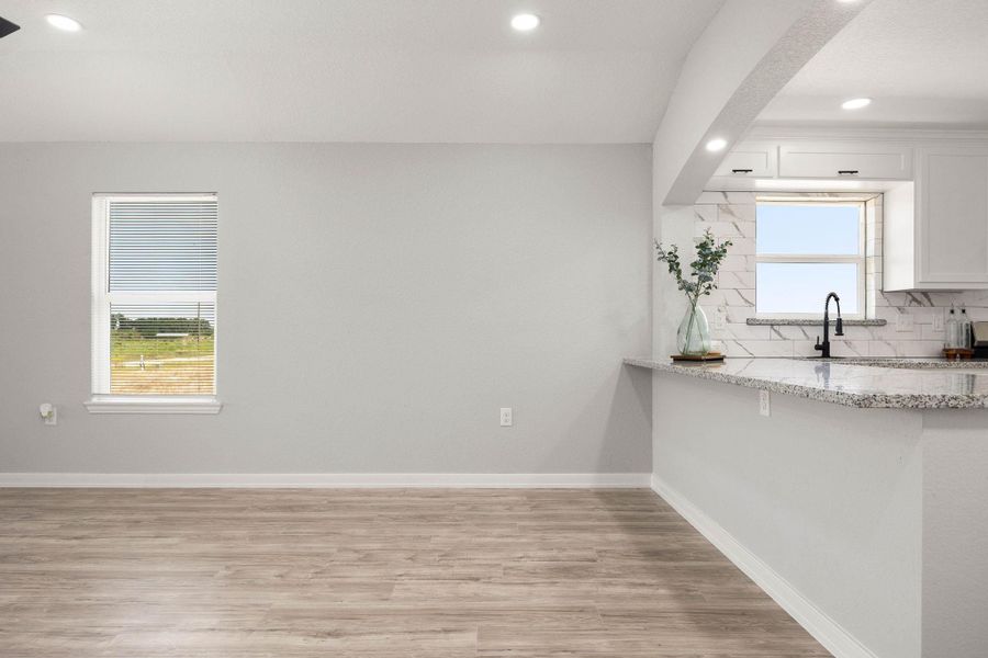 The layout seamlessly integrates extra counter space and stools, providing a functional and welcoming atmosphere that enhances the room's overall entertaining capabilities. The layout seamlessly integrates extra counter space and stools, providing a functional and welcoming atmosphere that enhances the room's overall entertaining capabilities.