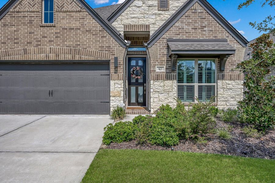 Front exterior of a new home in Grand Central Park 45', Conroe, TX, highlighting curb appeal (Image 1).