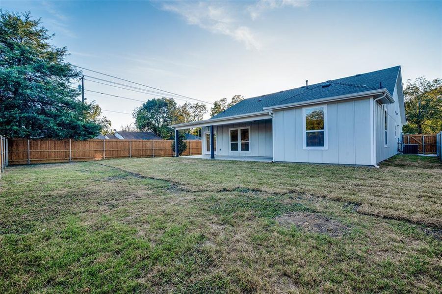 Back of property with a lawn and a patio area