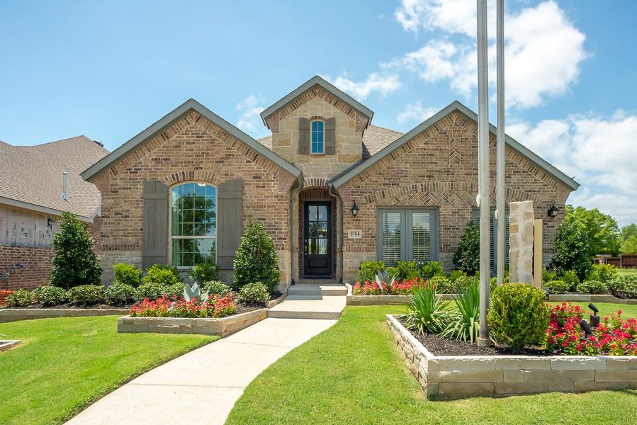 Front exterior of a new home in Wildridge, Oak Point, TX, highlighting curb appeal (Image 1).