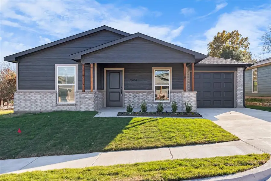 View of front facade featuring concrete driveway, an attached garage, a front lawn, and brick siding View of front facade featuring concrete driveway, an attached garage, a front lawn, and brick siding