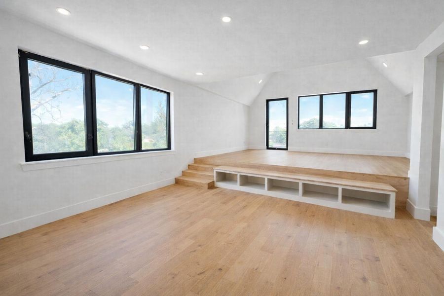 Light filled primary bedroom with a flexible layout for a sitting area or office, offering privacy and direct access to a private balcony to unwind.