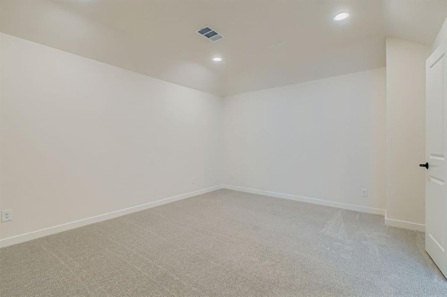 Spare room featuring light carpet and recessed lighting