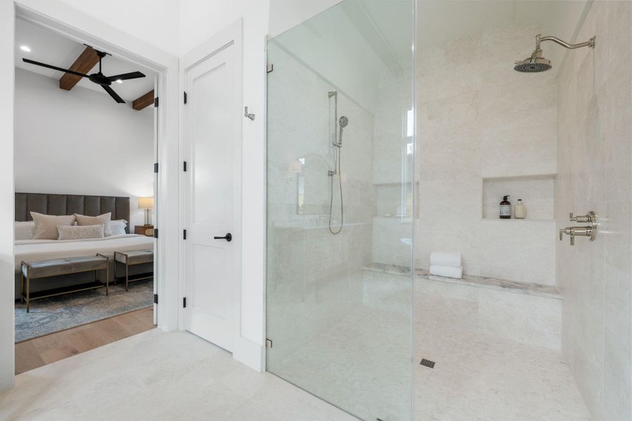 Bathroom with ensuite bathroom, a walk in shower, ceiling fan, beam ceiling, and wood finished floors Bathroom with ensuite bathroom, a walk in shower, ceiling fan, beam ceiling, and wood finished floors