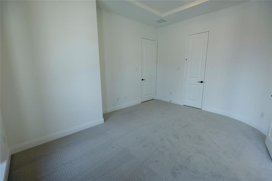 Empty room with light colored carpet