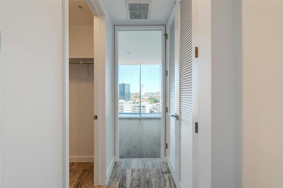 Hallway with light wood finished floors and a view of city