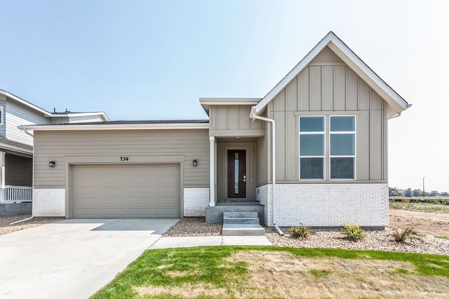 Front exterior of a new home in Prairie Song, Windsor, CO, highlighting curb appeal (Image 2). Front exterior of a new home in Prairie Song, Windsor, CO, highlighting curb appeal (Image 2).