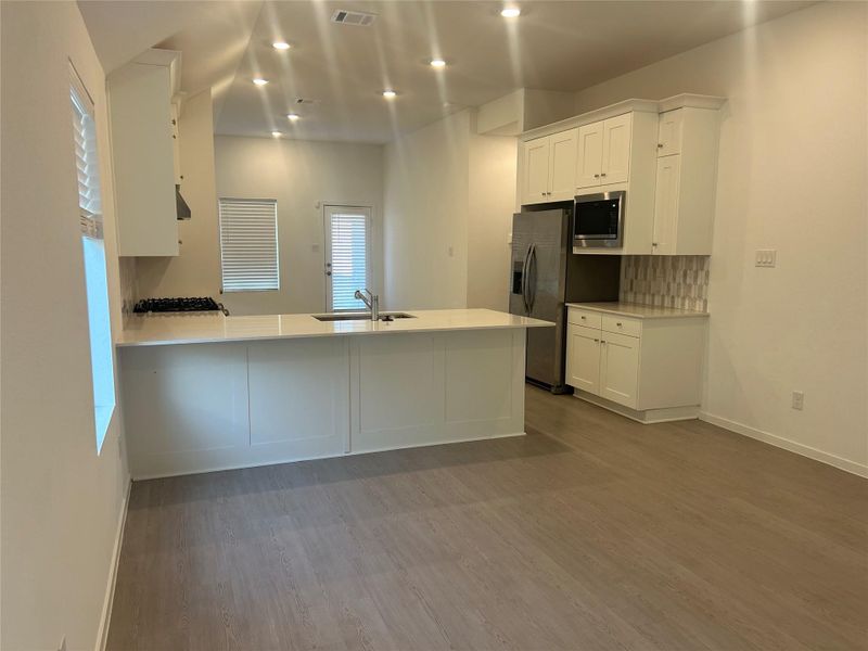 The view of the open concept Kichen and breakfast area from the Den. The view of the open concept Kichen and breakfast area from the Den.