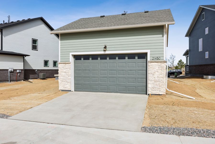 Exterior details and patio area of a home in Painted Prairie Meadow Collection, Aurora (Image 3).