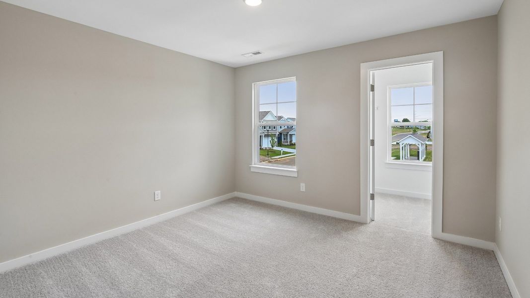 Bedroom with walk-in closet and window