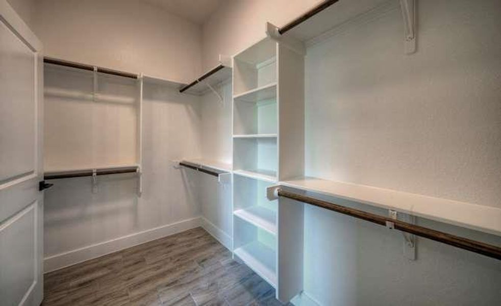 An organized closet system with built-in shelves and ample hanging space maximizes storage capacity.