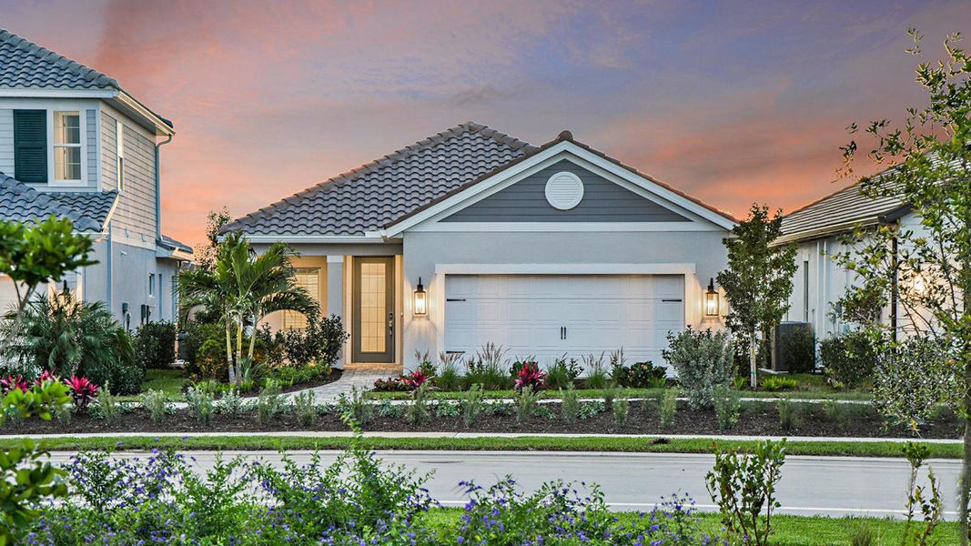 Front exterior of a new home in SkySail Real Estate and Homes for Sale in Naples, FL - Neal Communities, Naples, FL, highlighting curb appeal (Image 21).