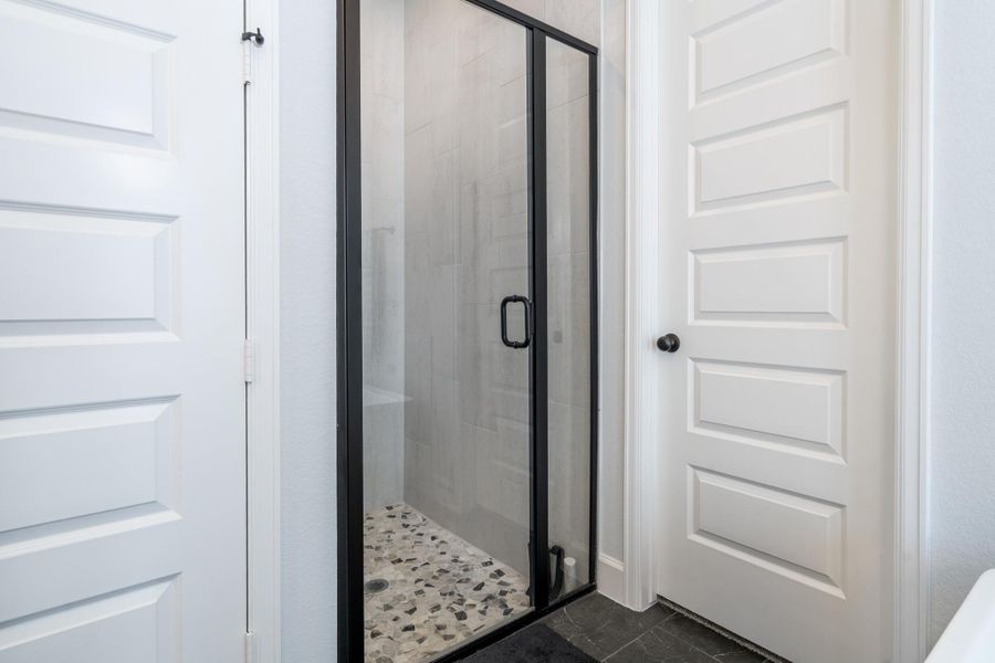You can't see it in this photos, but the upgraded shower tile has been continued all the way to the ceiling in a vertical pattern for an incomparable look. There are also two separate primary closets with built-in shelving. You can't see it in this photos, but the upgraded shower tile has been continued all the way to the ceiling in a vertical pattern for an incomparable look. There are also two separate primary closets with built-in shelving.