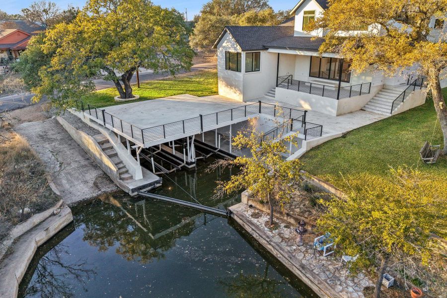 Positioned on a private cove, this home features 81 feet of water frontage. The private boathouse establishes the ultimate setting for sunset gatherings. Boating is a breeze with the boathouse's dual electric lifts. Entertain guests from the spectacular overhead entertainment deck.