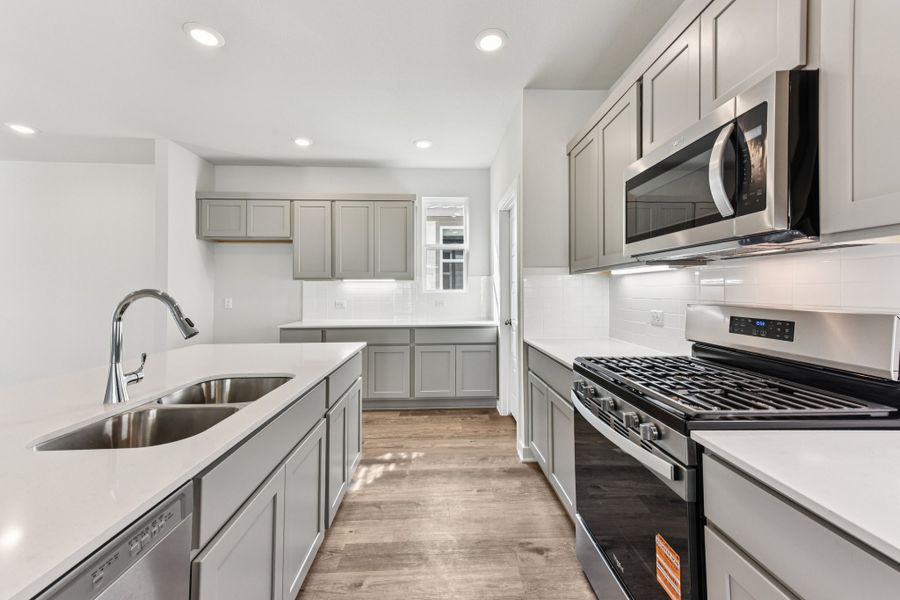 A kitchen with white cabinets.