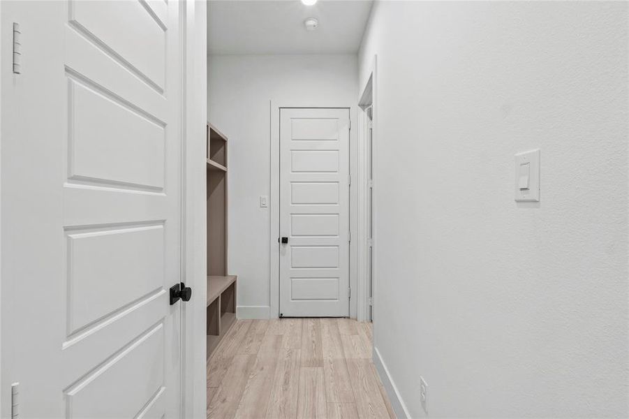 Corridor with light hardwood / wood-style floors