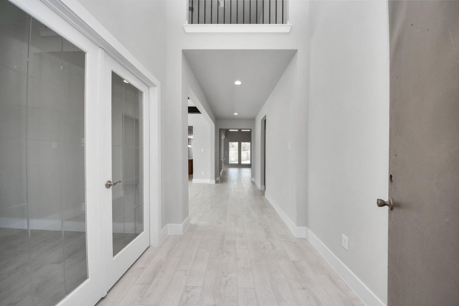 As you step into the threshold of this luxurious home, you'll soon be welcomed by an elegant glass door (to be installed). Inside, soaring ceilings amplify the spaciousness, while the refined wood-look tile flooring and oversized baseboards exude sophistication and charm.