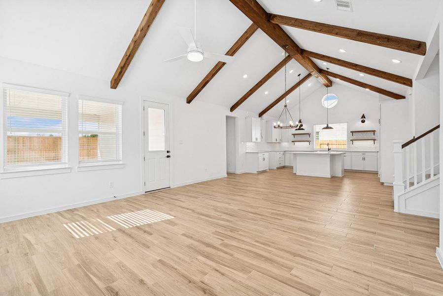 Bright and open living space with vaulted ceilings and stained beams
