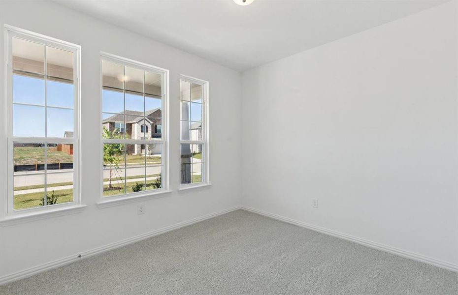 Guest bedroom on first level with large windows