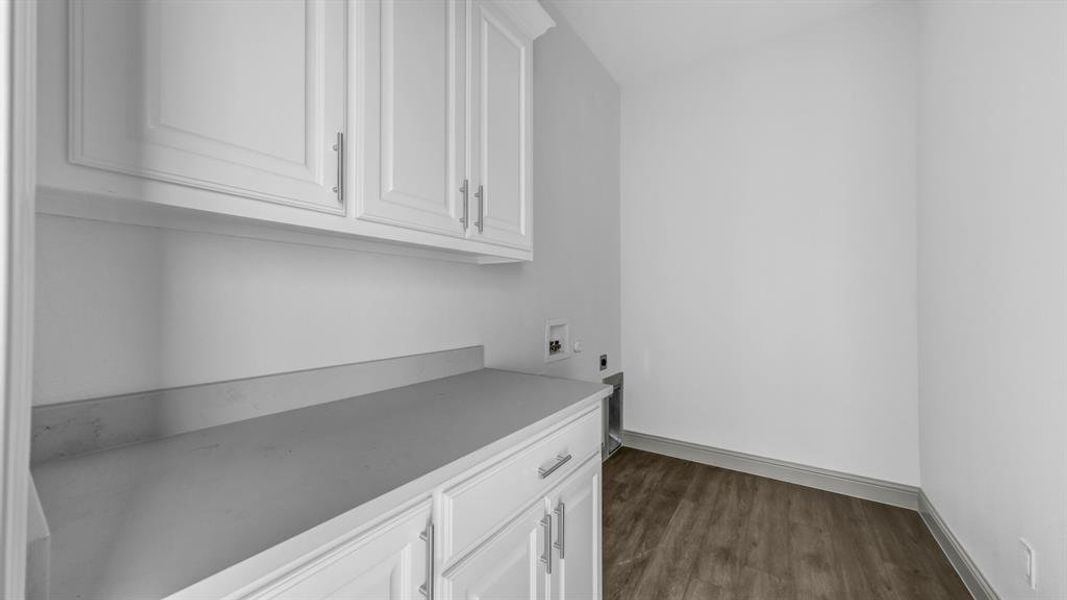 Handy counter space in a dedicated utility room with plenty of cabinet storage.