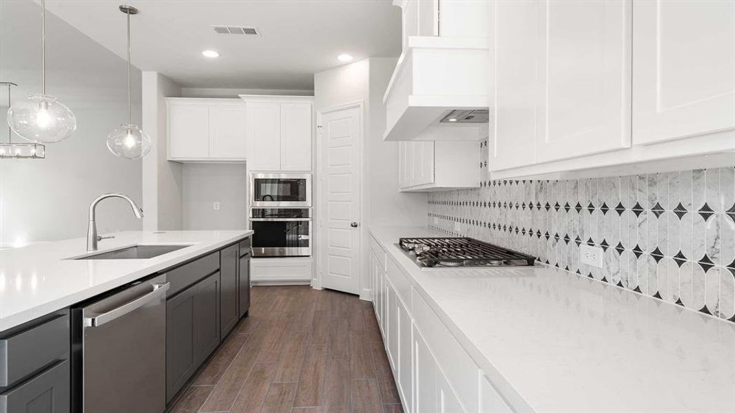 Kitchen with backsplash, white cabinetry, dark hardwood / wood-style floors, stainless steel appliances, and sink