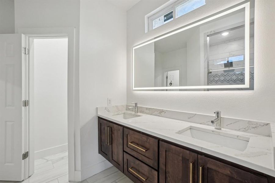 Primary Bathroom featuring double sink vanity