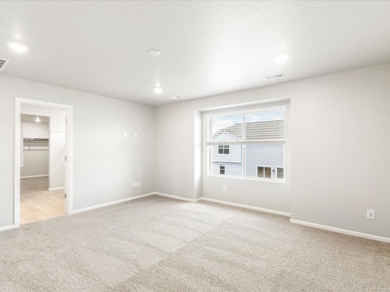 Primary bedroom in the Wateron floorplan at a Meritage Homes community in Brighton, CO.