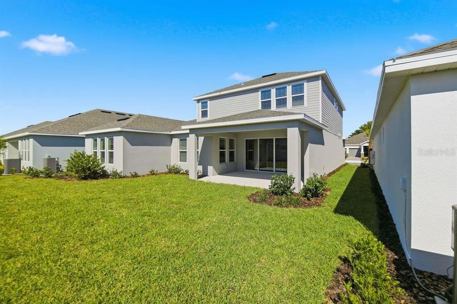 Exterior details and patio area of a home in Harvest at Ovation, Winter Garden (Image 2).