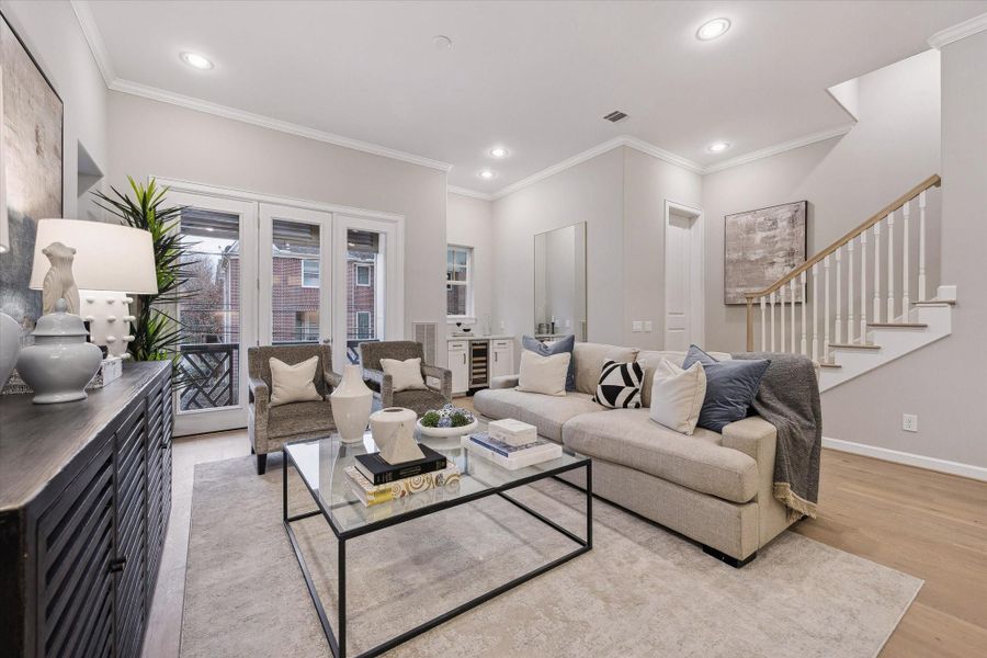 Open-concept living area with engineered wood flooring and abundant natural light.