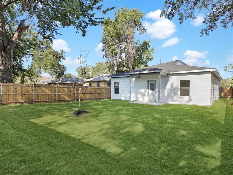 Back of property featuring a yard and a patio area