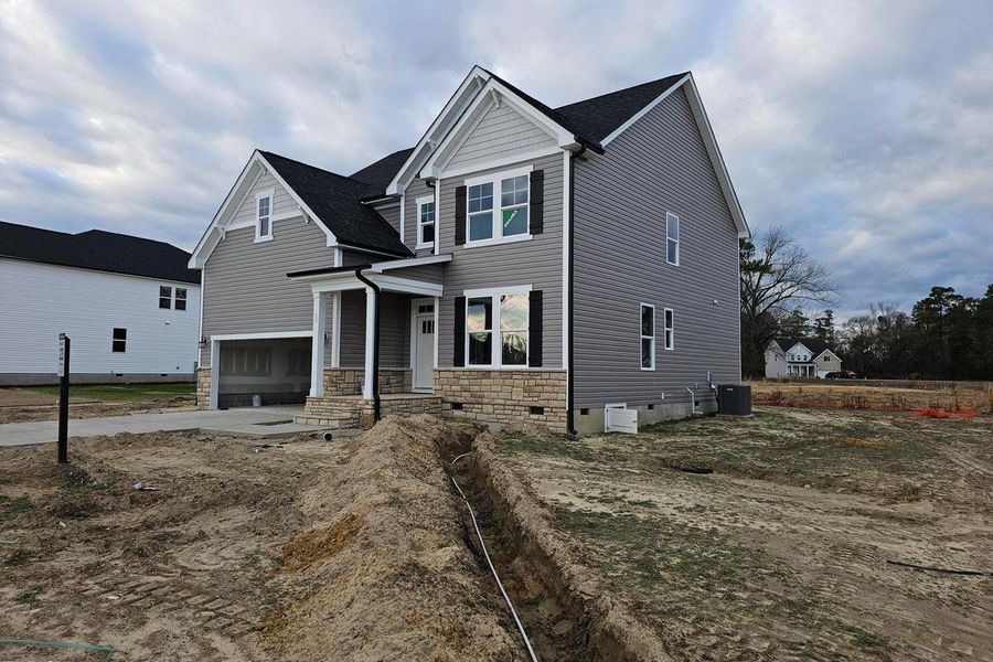 Front exterior of a new home in Wellers Knoll, Lillington, NC, highlighting curb appeal (Image 4). Front exterior of a new home in Wellers Knoll, Lillington, NC, highlighting curb appeal (Image 4).