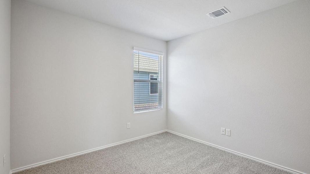 Spare room featuring carpet floors and baseboards