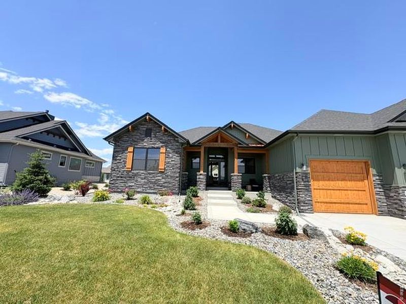 Front exterior of a new home in Harvest Ridge, Berthoud, CO, highlighting curb appeal (Image 26).